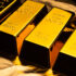 Gold bars on shiny yellow background.