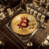 Gold Bit Coin BTC coins on the motherboard. Bitcoin is a worldwi