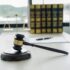 The judge's gavel at the law firm has scales, scales of justice, and litigation documents. Concepts