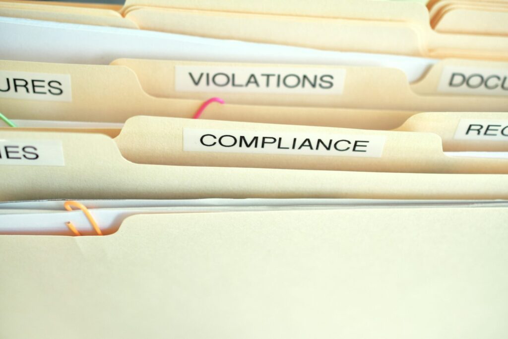 Compliance in the workplace. Folders labeled Compliance, Violations in focus. belize.