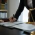 Confident lawyer or businessman examining details in real estate legal contract document Legal servi
