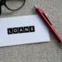 The word LOAN on white paper with a red pen