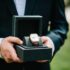 Cropped shot of a man wearing elegant suit and hold wrist watch. Man hand with elegant expensive
