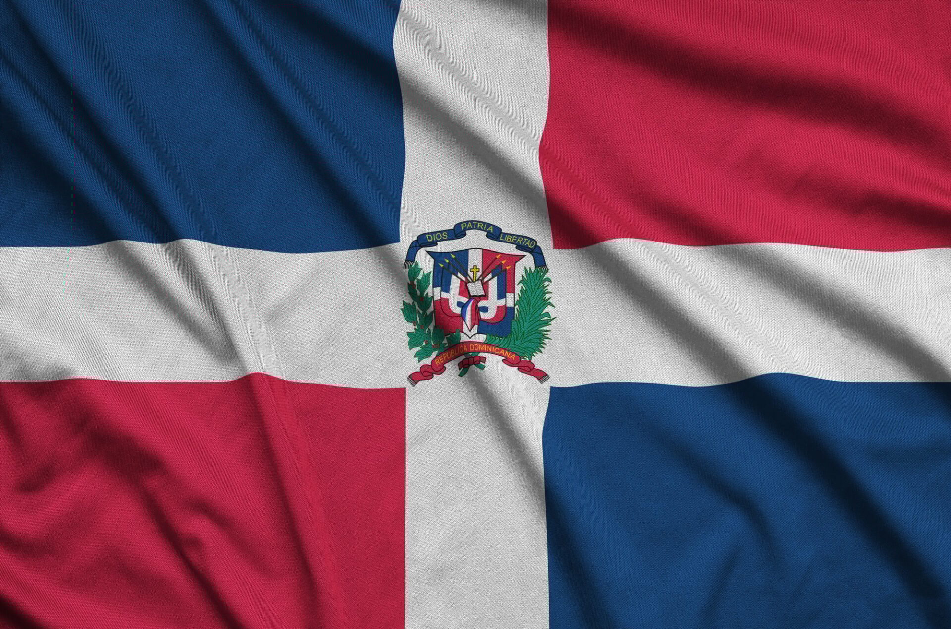 Dominican Republic flag is depicted on a sports cloth fabric with many folds