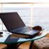 Laptop on the table on the hotel balcony with sea view. Remote work, doing business