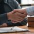 Lawyers shake hands with business people to seal a deal with partner lawyers. or a lawyer discussing